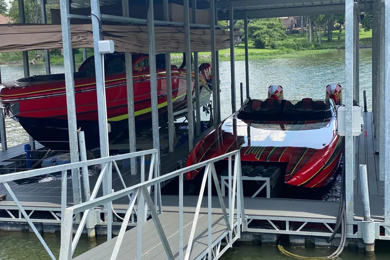 Slide: The Image of Two red Doug Wright P360 boats docked on a lake, 2021 model. - 3