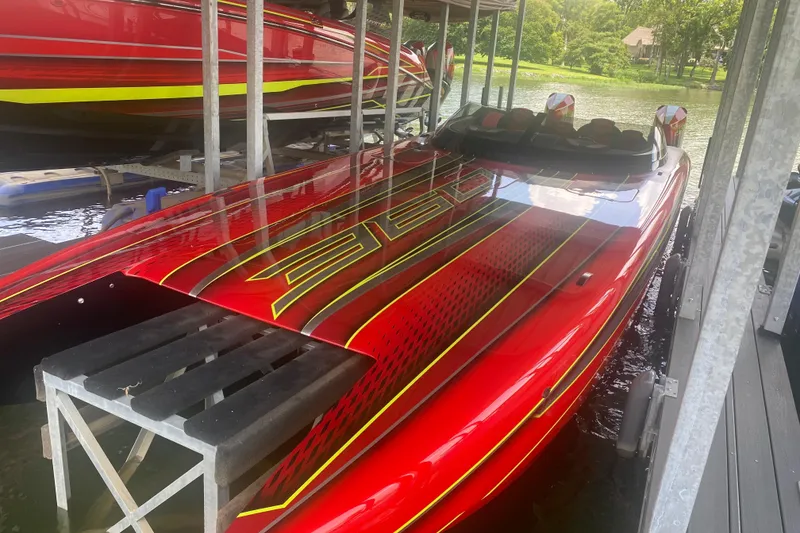 Slide: The Image of Red 2021 Doug Wright P360 powerboat docked, featuring sleek design and vibrant graphics. - 8