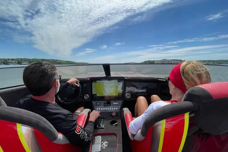 Slide: The Image of Two people navigating a Doug Wright P360 boat on a sunny day, 2021 model. - 7