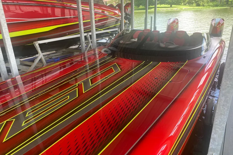 Slide: The Image of Red Doug Wright P360 powerboat, 2021 model, docked with vibrant yellow and black accents. - 7