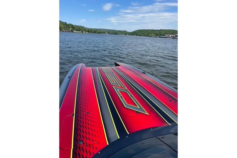 Slide: The Image of Red Doug Wright P360 boat on a lake, showcasing sleek design and vibrant colors. - 4
