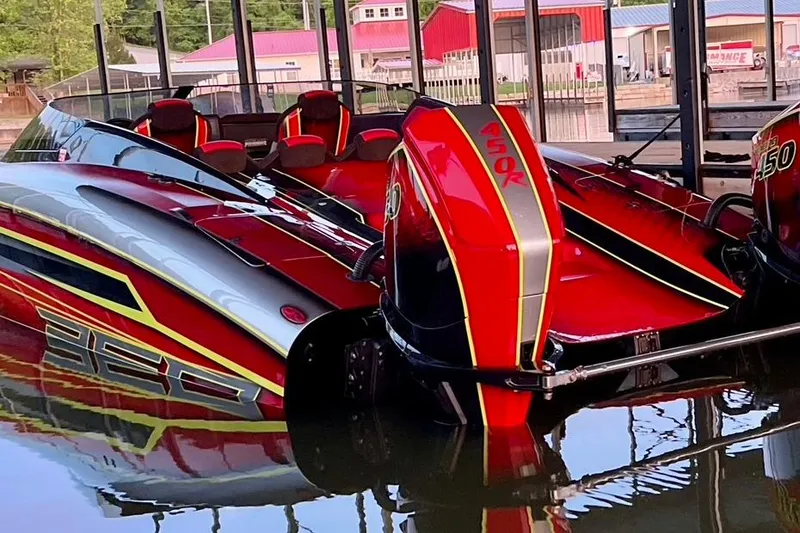 Slide: The Image of Red and black Doug Wright P360 powerboat with dual 450R engines docked in 2021. - 3