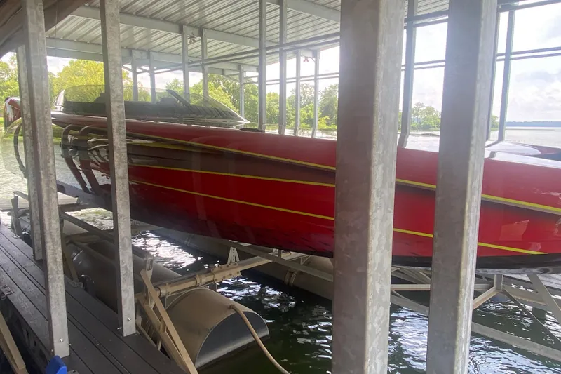Slide: The Image of Red Doug Wright P360 boat docked in a covered marina, 2021 model. - 10