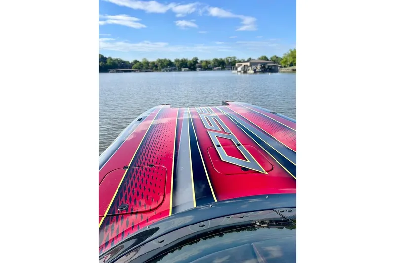 Slide: The Image of Red Doug Wright P360 boat on a serene lake, 2021 model. - 6
