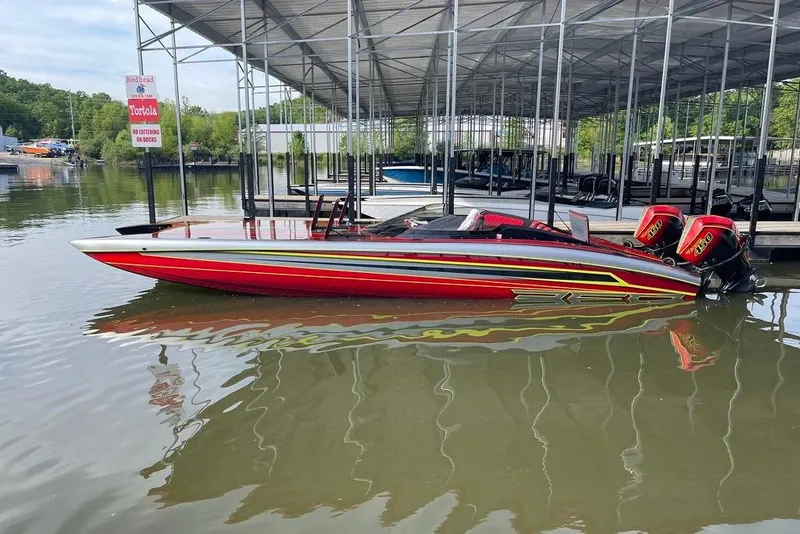 Slide: The Image of Red Doug Wright P360 powerboat with twin engines docked in a marina, 2021 model. - 8
