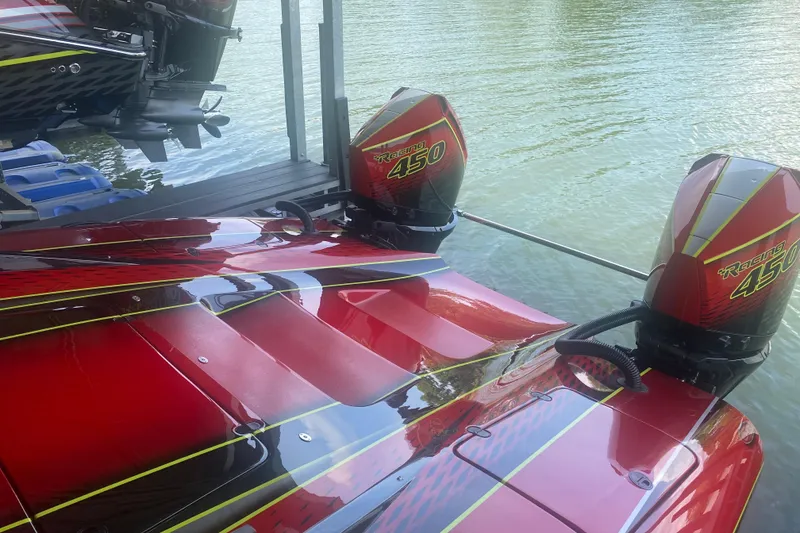 Slide: The Image of Red Doug Wright P360 boat with twin Racing 450 engines on a calm lake. - 6