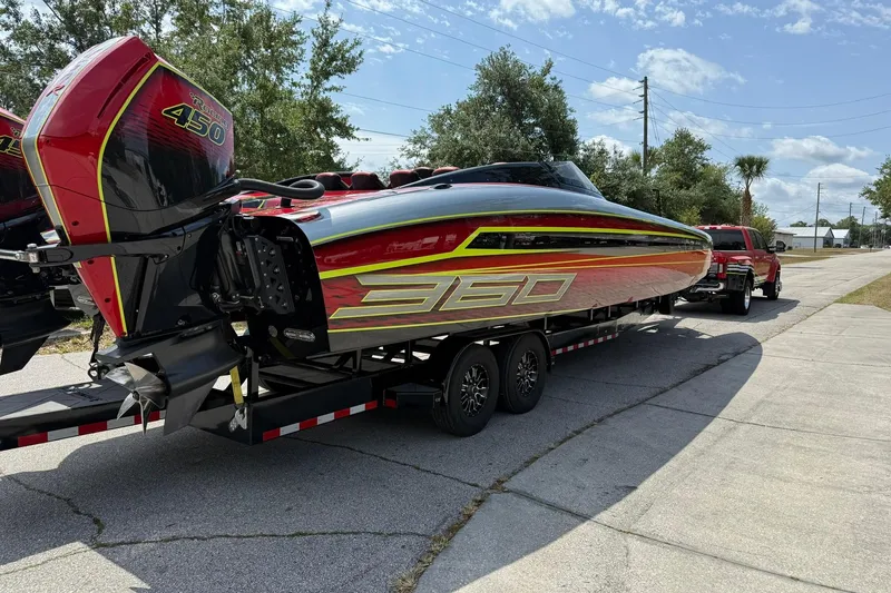 Slide: The Image of 2021 Doug Wright P360 powerboat on trailer, featuring vibrant red and yellow design. - 5