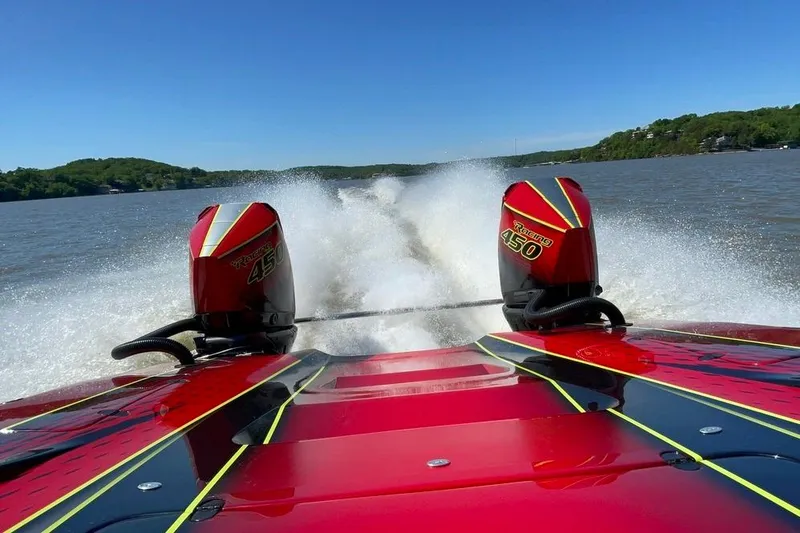 Slide: The Image of Red Doug Wright P360 boat with twin Racing 450 engines speeding on a lake. - 9