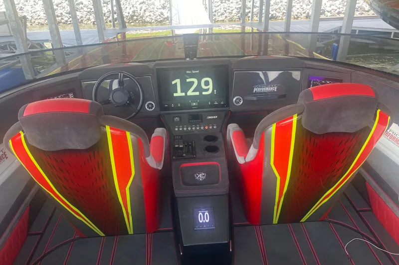 Slide: The Image of Interior of a 2021 Doug Wright P360 boat with vibrant red seats and digital dashboard. - 5