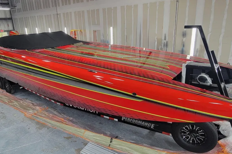 The Image of Red Doug Wright P360 powerboat, 2021 model, with sleek design in a workshop setting. - 0
