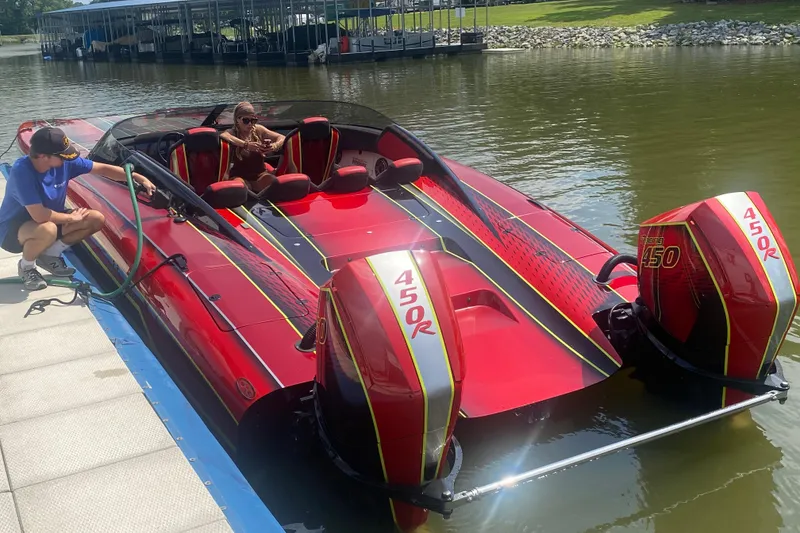 Slide: The Image of Red Doug Wright P360 powerboat with twin 450R engines docked at a marina, 2021 model. - 1