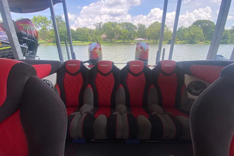 Slide: The Image of The image shows a boat interior with red and black seats. A river is visible in the background. - 4