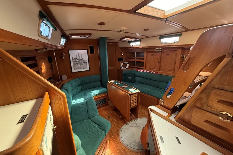 Slide: The Image of Interior of 1993 Tartan 4600 yacht with wooden furnishings and green seating. - 40