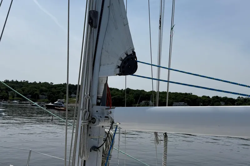 Slide: The Image of Sailboat mast and rigging on a 1993 Tartan 4600, with a scenic waterfront background. - 9