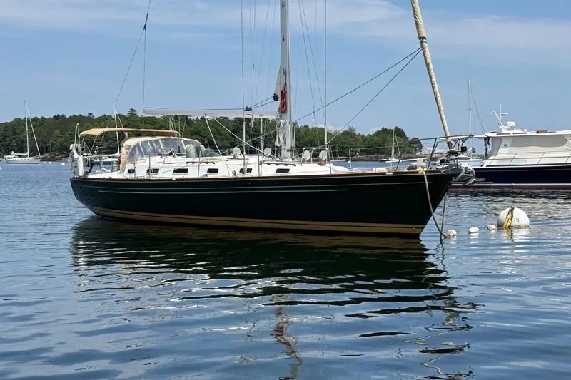 Slide: The Image of Sailboat Tartan 4600, 1993 model, anchored in calm waters with scenic background. - 3