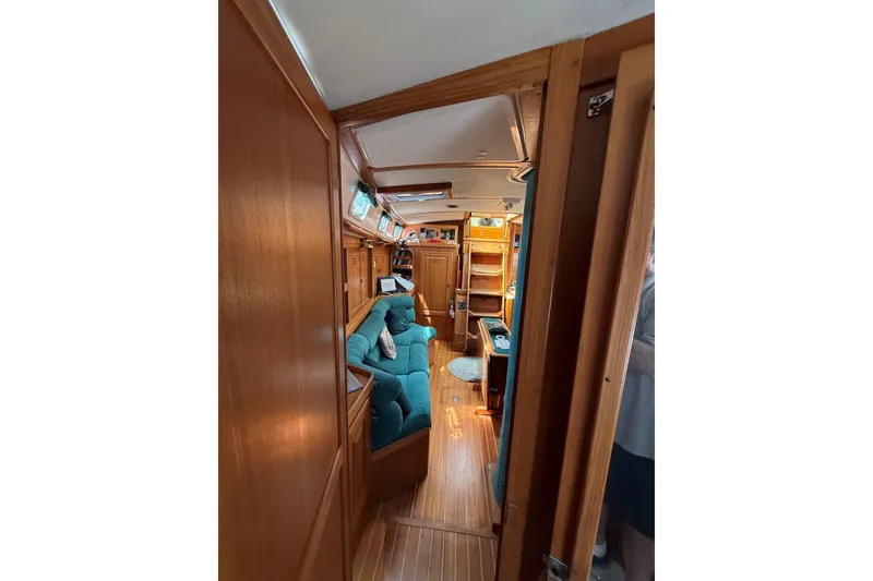 Slide: The Image of Interior of 1993 Tartan 4600 yacht with wooden paneling and teal seating. - 32