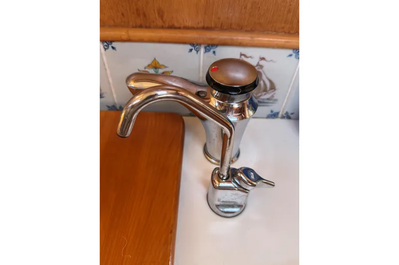 Slide: The Image of Chrome faucet on a Tartan 4600 yacht, 1993 model, with nautical-themed tiles. - 24