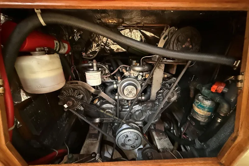 Slide: The Image of Engine compartment of a 1993 Tartan 4600 sailboat, showcasing mechanical components and hoses. - 34