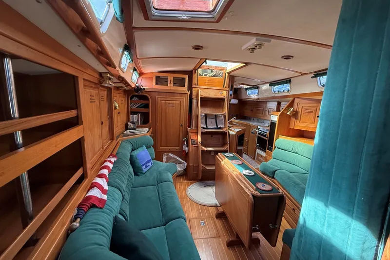 Slide: The Image of Luxurious interior of a 1993 Tartan 4600 yacht with wooden finishes and green upholstery. - 37
