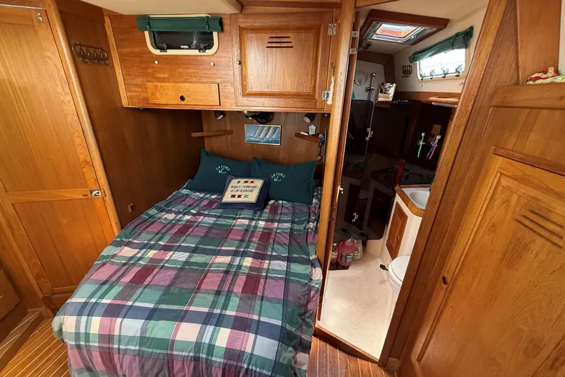 Slide: The Image of Cozy cabin interior of 1993 Tartan 4600 sailboat with bed and bathroom. - 16