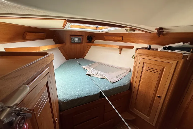 Slide: The Image of Cozy cabin interior of 1993 Tartan 4600 sailboat with wooden furnishings and a skylight. - 43