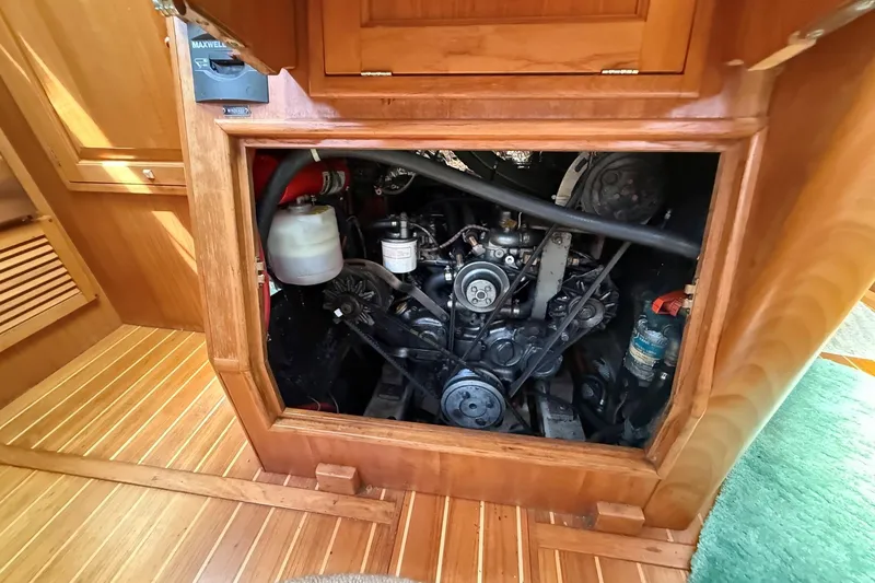 Slide: The Image of Engine compartment of a 1993 Tartan 4600 sailboat, showcasing mechanical components. - 33