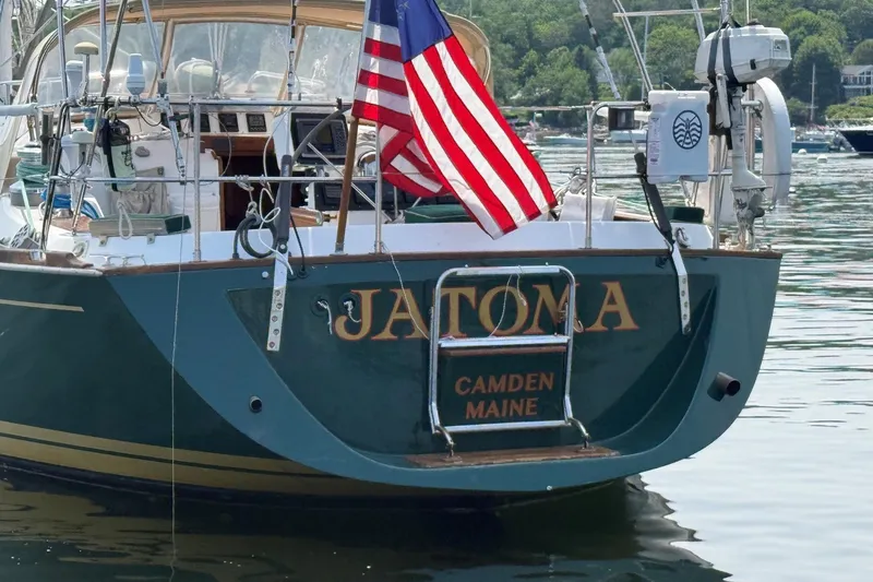 Slide: The Image of Sailboat "Jatoma" docked in Camden, Maine, featuring American flag, Tartan 4600 model, 1993. - 4