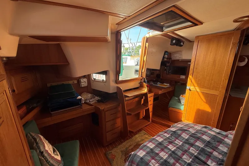 Slide: The Image of Cozy interior of a 1993 Tartan 4600 sailboat with wooden furnishings and natural light. - 18