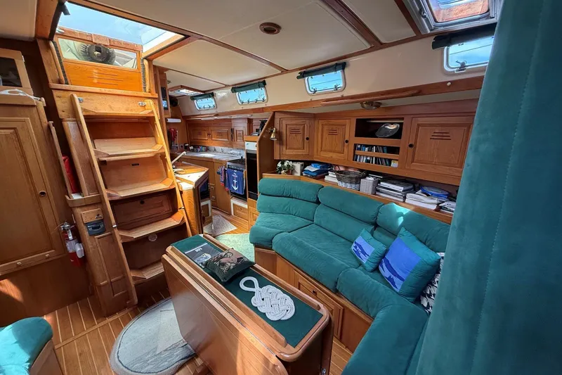 Slide: The Image of Interior of a 1993 Tartan 4600 yacht with cozy seating and wooden cabinetry. - 28