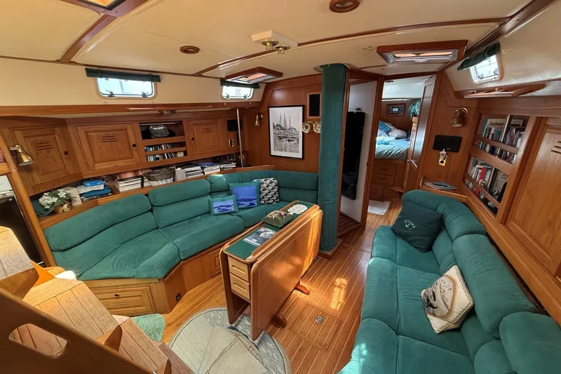 Slide: The Image of Luxurious 1993 Tartan 4600 yacht interior with teal seating and wooden cabinetry. - 27