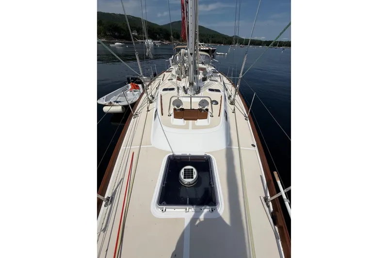 Slide: The Image of 1993 Tartan 4600 sailboat deck view on calm water with scenic background. - 7