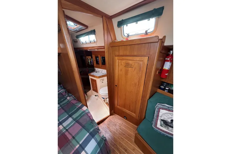Slide: The Image of Interior of 1993 Tartan 4600 sailboat with wood paneling and compact bathroom. - 18