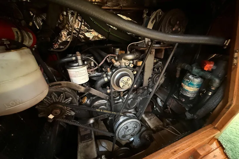 Slide: The Image of Engine compartment of a 1993 Tartan 4600 sailboat, showcasing mechanical components and hoses. - 35