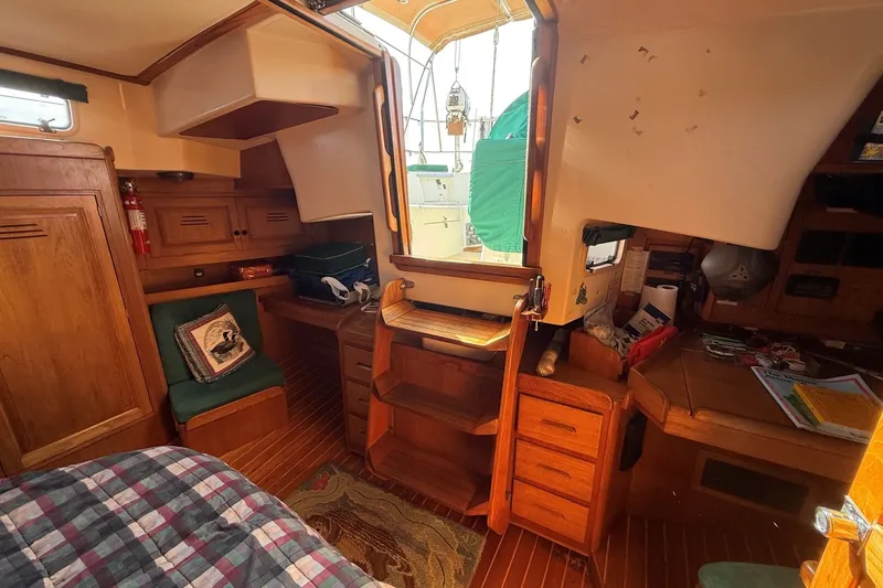 Slide: The Image of Cozy interior of a 1993 Tartan 4600 sailboat with wooden cabinetry and seating. - 20