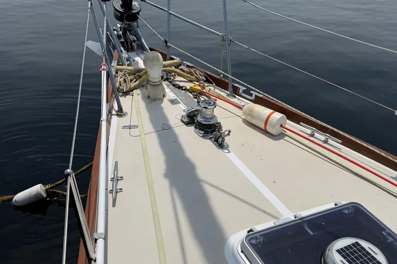 Slide: The Image of Deck of 1993 Tartan 4600 sailboat with ropes and winch, floating on calm water. - 8