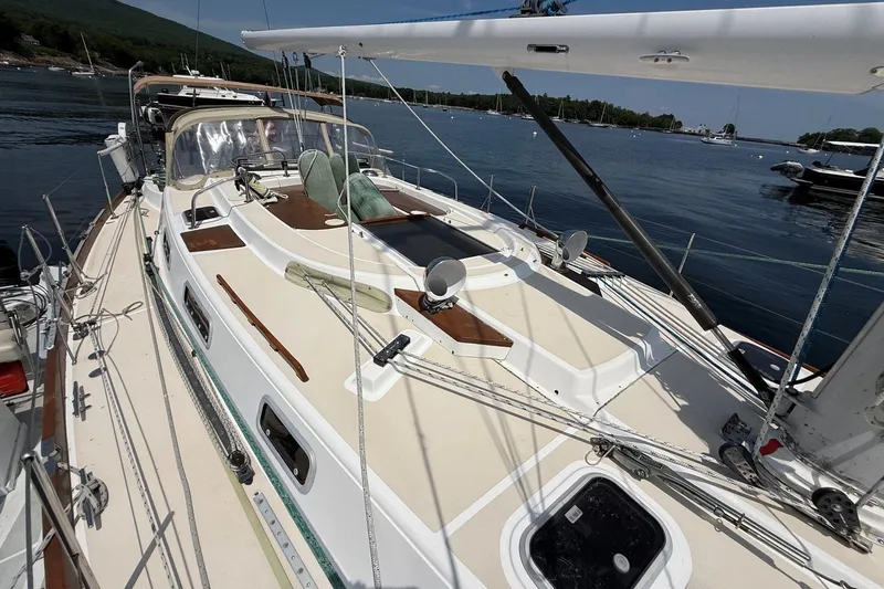 Slide: The Image of Sailboat Tartan 4600, 1993 model, docked at a serene marina with clear skies. - 5