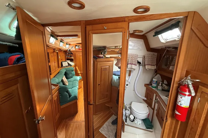 Slide: The Image of Interior of 1993 Tartan 4600 yacht with wooden cabinetry and cozy seating area. - 19