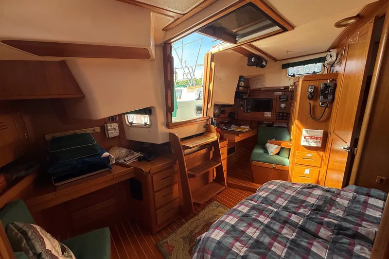 Slide: The Image of Cozy interior of a 1993 Tartan 4600 sailboat with wooden furnishings and navigation equipment. - 19