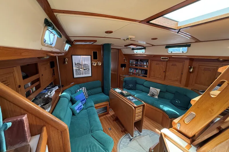 Slide: The Image of Luxurious 1993 Tartan 4600 yacht interior with teal seating and wooden cabinetry. - 26