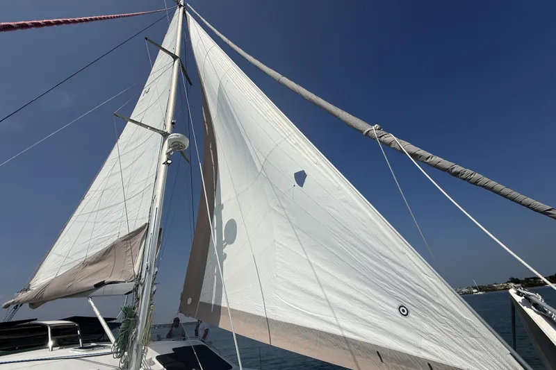 Slide: The Image of Sailing yacht Voyage 440 (2002) with sails unfurled against a clear blue sky. - 35