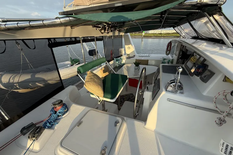 Slide: The Image of Cockpit of 2002 Voyage 440 yacht with seating, steering wheel, and nautical equipment. - 8