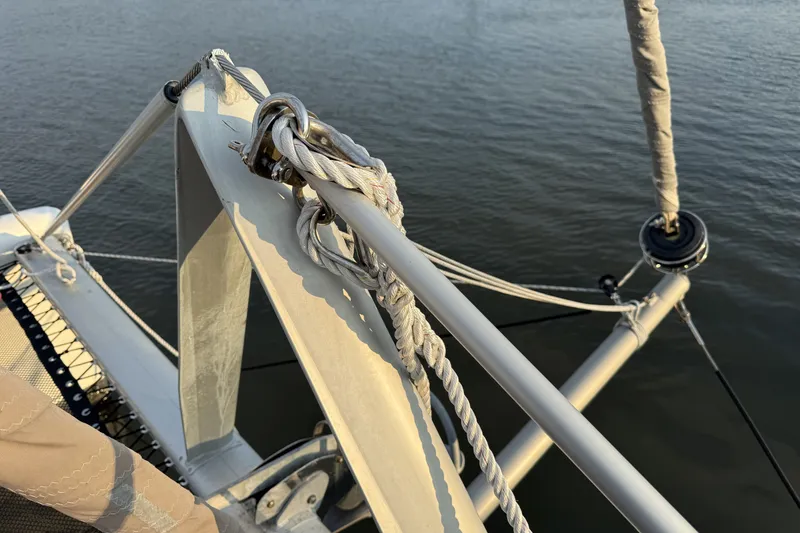 Slide: The Image of Close-up of a 2002 Voyage 440 sailboat rigging over calm water. - 39