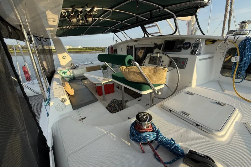 Slide: The Image of Cockpit of 2002 Voyage 440 yacht with seating, steering wheel, and nautical equipment. - 6