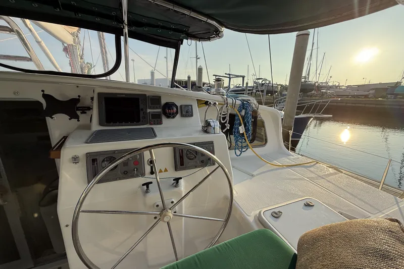 Slide: The Image of Cockpit of 2002 Voyage 440 sailboat at sunset in marina. - 7