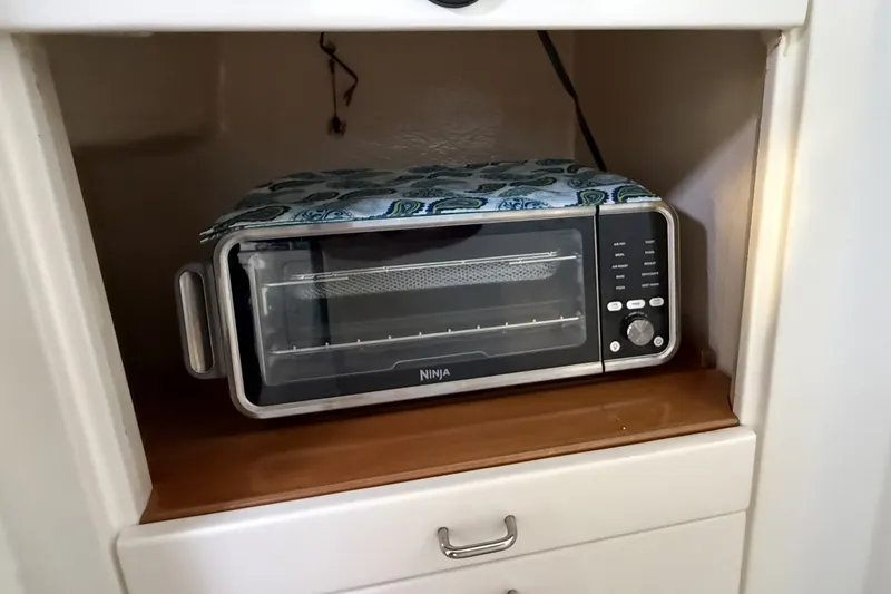 Slide: The Image of Toaster oven in a kitchen cabinet on a Voyage 440, 2002 model. - 38