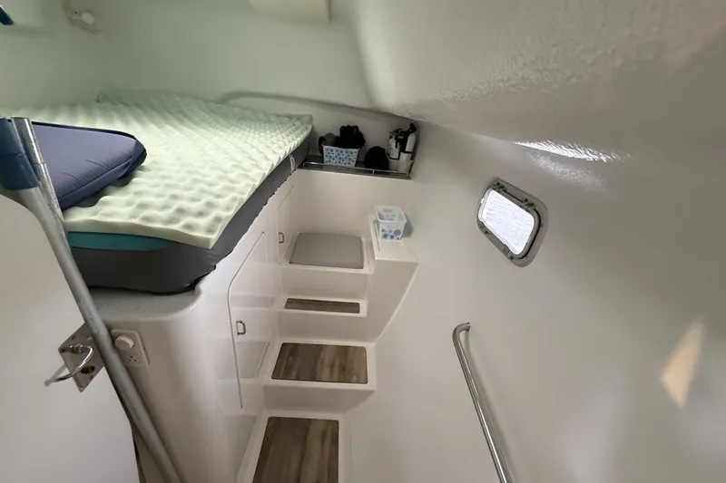 Slide: The Image of Interior cabin of 2002 Voyage 440 yacht with bed, steps, and porthole. - 23
