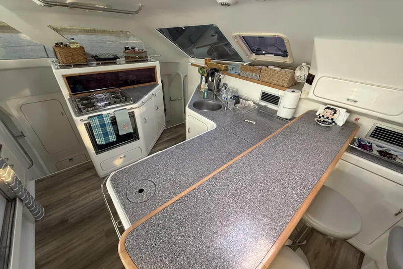 Slide: The Image of Modern kitchen interior of 2002 Voyage 440 yacht with sleek countertops and appliances. - 15