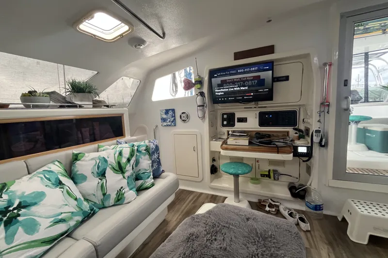 Slide: The Image of Interior of a 2002 Voyage 440 yacht with cozy seating and modern navigation equipment. - 17