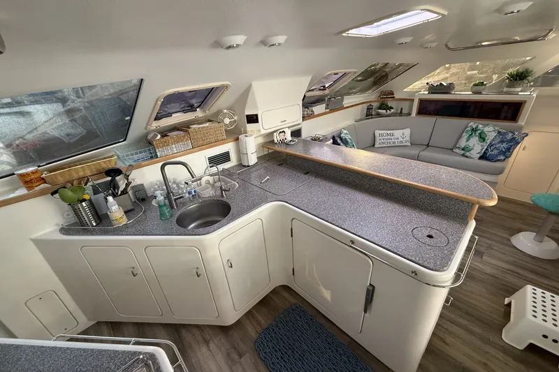 Slide: The Image of Spacious interior of 2002 Voyage 440 yacht with modern kitchen and cozy seating area. - 13
