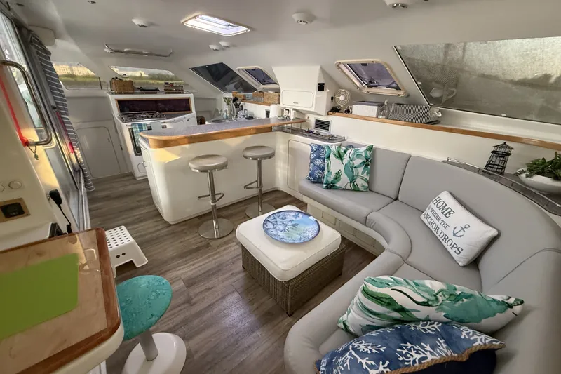 Slide: The Image of Luxurious interior of a 2002 Voyage 440 yacht with modern kitchen and cozy seating area. - 1